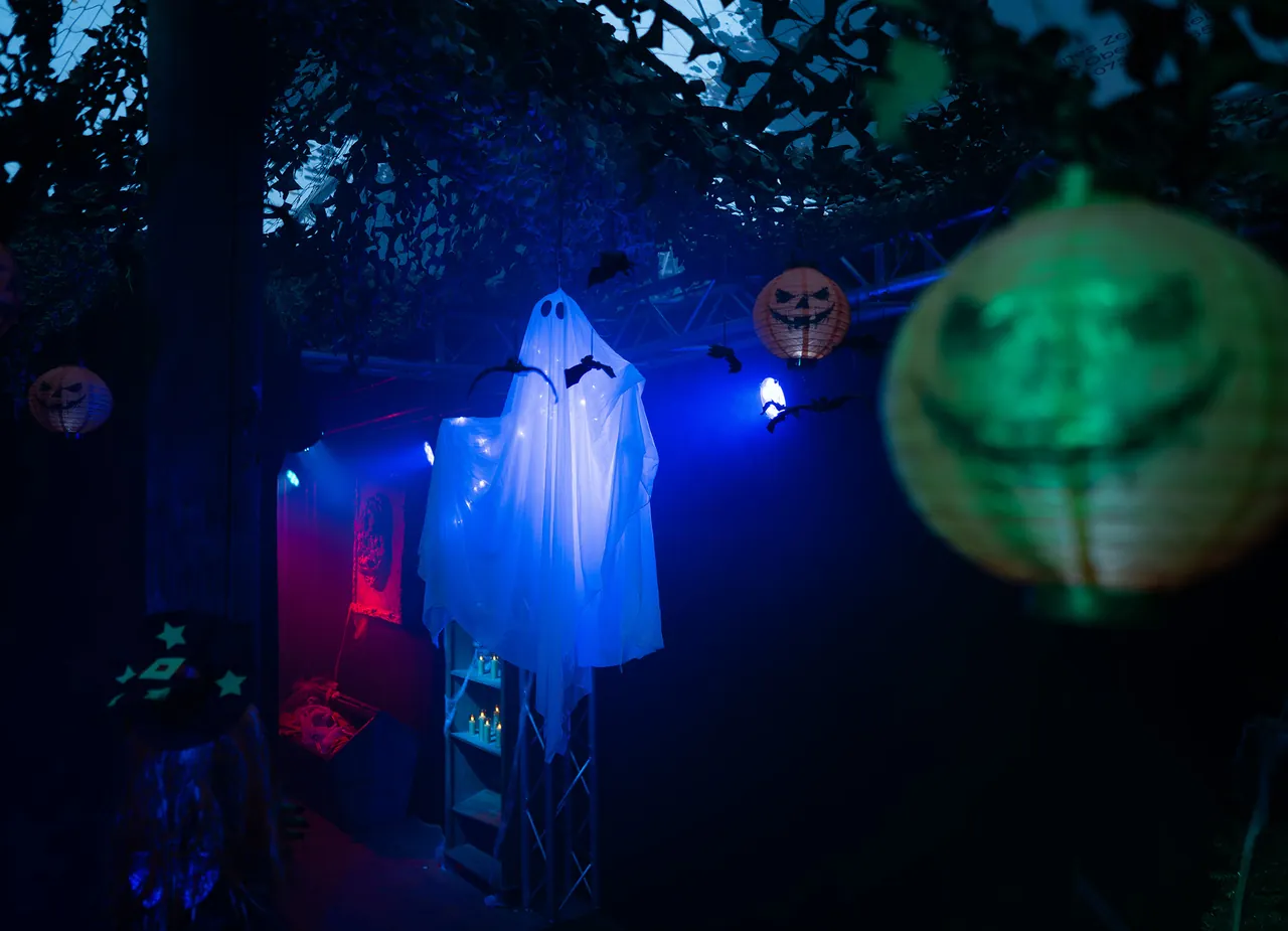 Gespensterfigur und leuchtende Laternen am Halloween-Haus im Ravensburger Spieleland